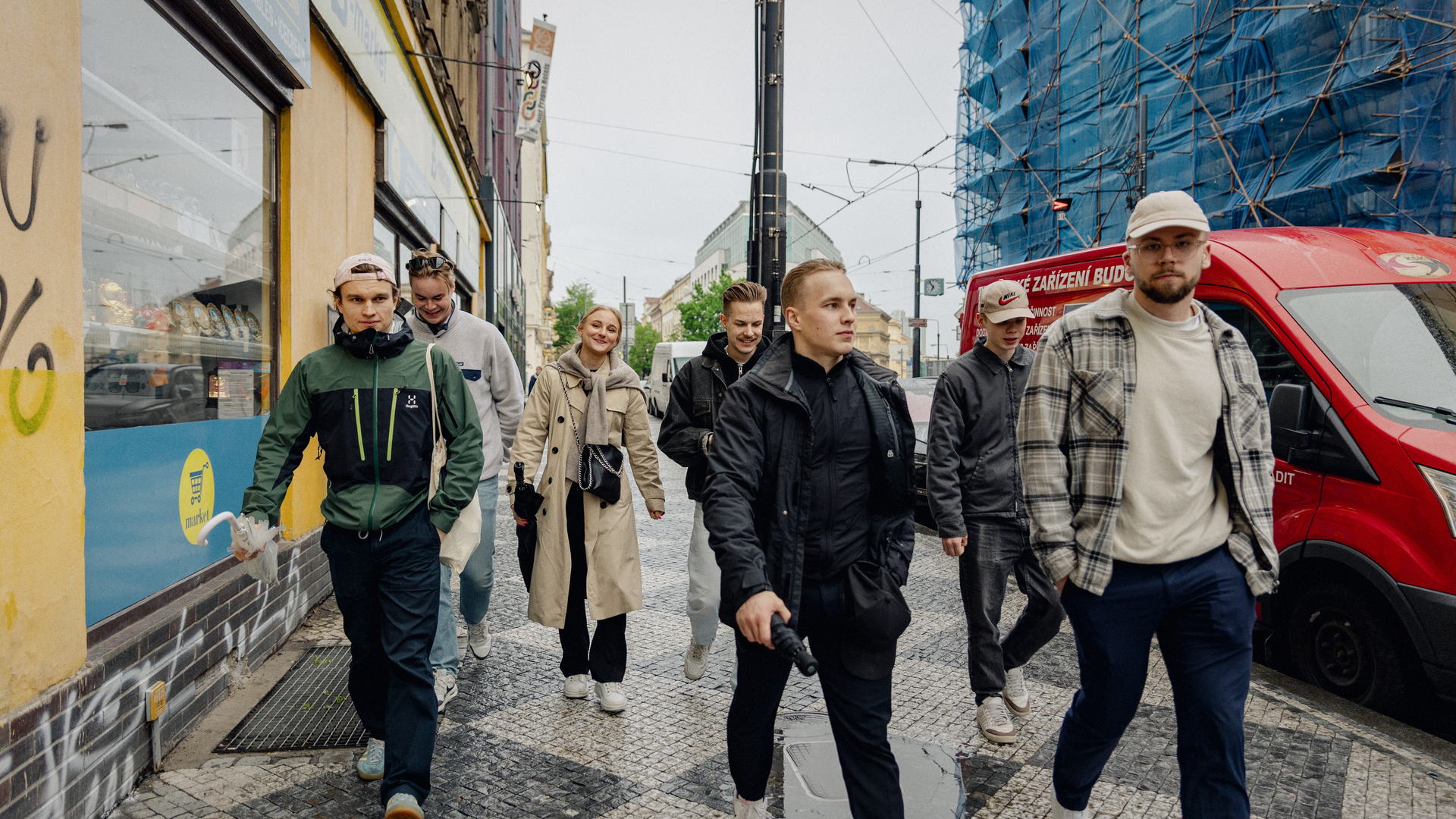The team walking down a street in Prague