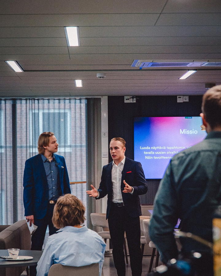 Two team members presenting to a business audience at the Chamber of Commerce