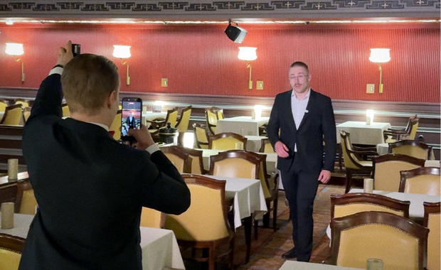A team member filming a colleague