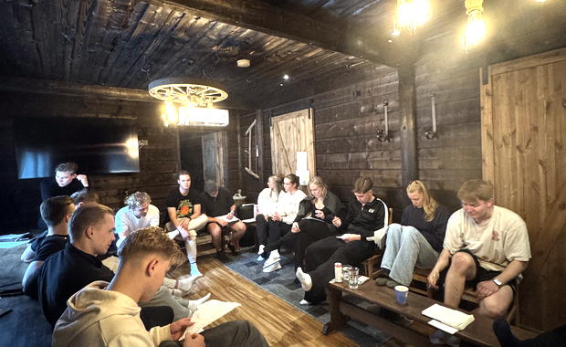 The team in a circle in discussion